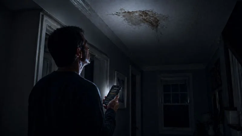 A homeowner discovering a problem and searching for help on their phone